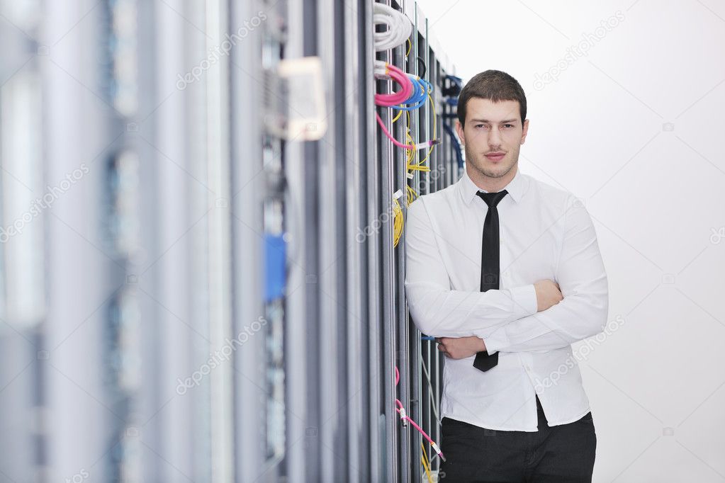 Young handsome business man it engineer in datacenter server room