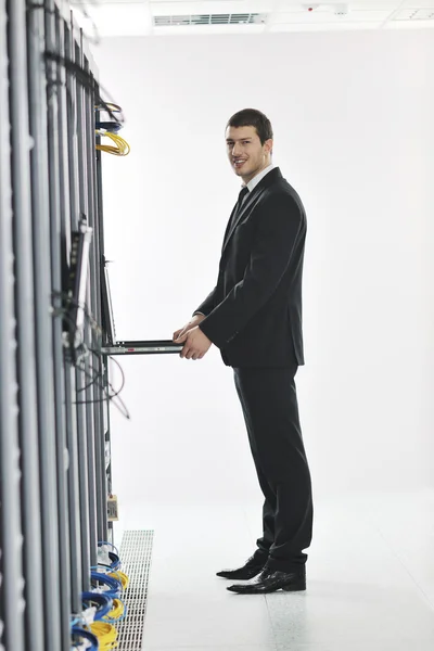 Young handsome business man it engineer in datacenter server room — ストック写真