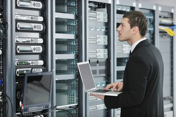 Young handsome business man it engineer in datacenter server room Royalty Free Stock Images
