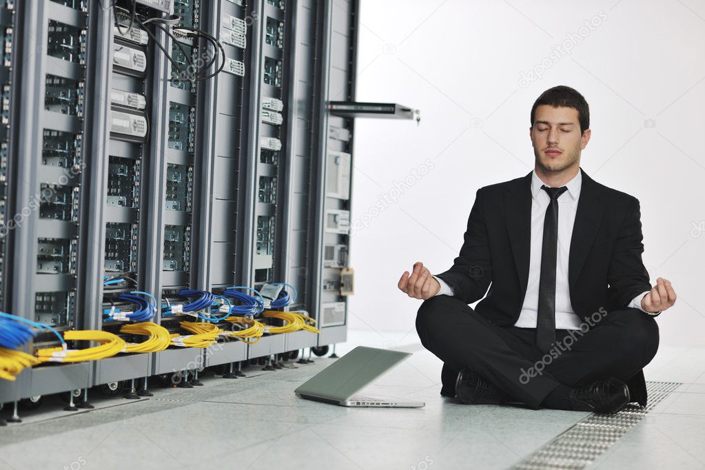 Young handsome business man it engineer in datacenter server room