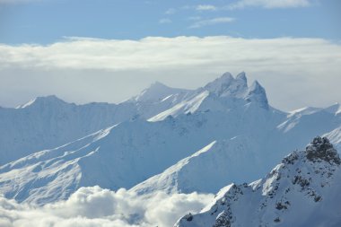 Mountain snow fresh sunset at ski resort in france val thorens clipart