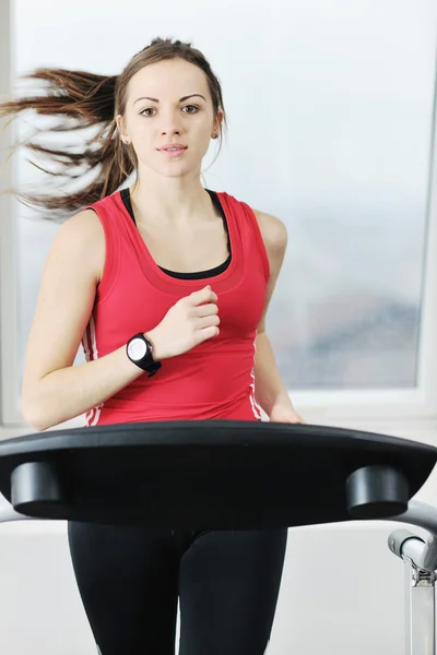 Womanworkout in fitness club on running track machine — Stock Photo, Image