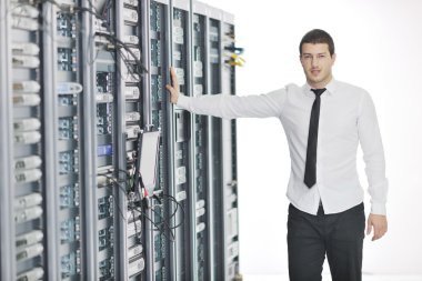 Young it engeneer in datacenter server room clipart