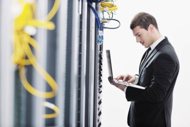 Business man practice yoga at network server room clipart