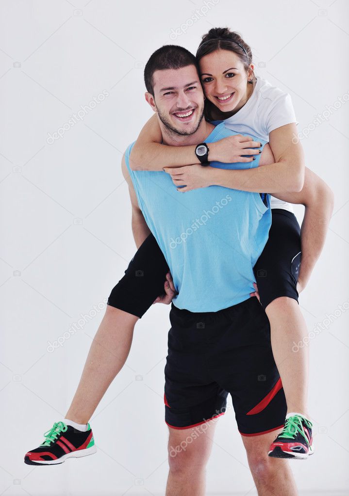 Happy young couple fitness workout and fun at sport gym club
