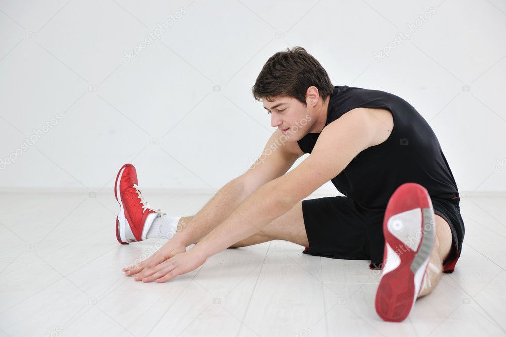 Young man in fintess sport club exercise withweights and relaxing