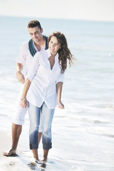 Счастливая молодая пара веселится на красивом пляже — стоковое фото