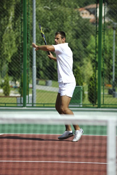 Νεαρός άνδρας παίζουν τένις υπαίθρια — Φωτογραφία Αρχείου