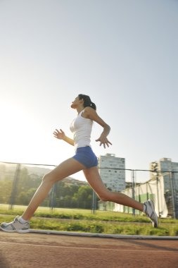 Woman jogging at early morning clipart