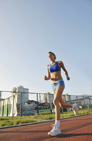 美しい若い女性運動のジョギングと日の出スタジアムで陸上競技場を Runing — ストック写真