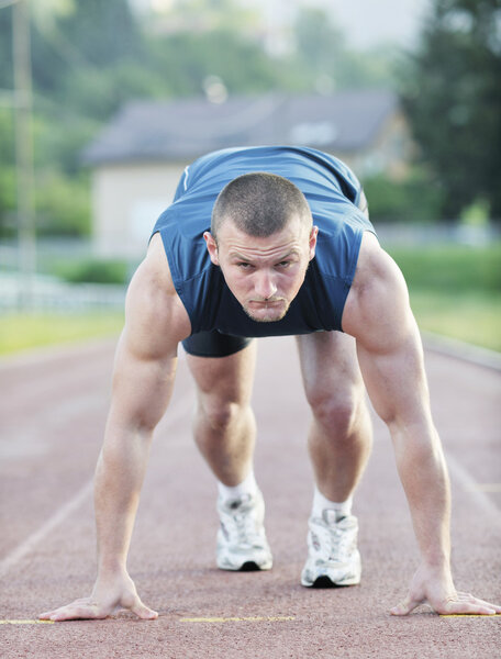 Healthy young man at start line ready for run race and win