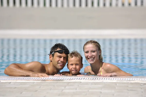 Happy young family have fun on swimming pool — Stock Photo, Image