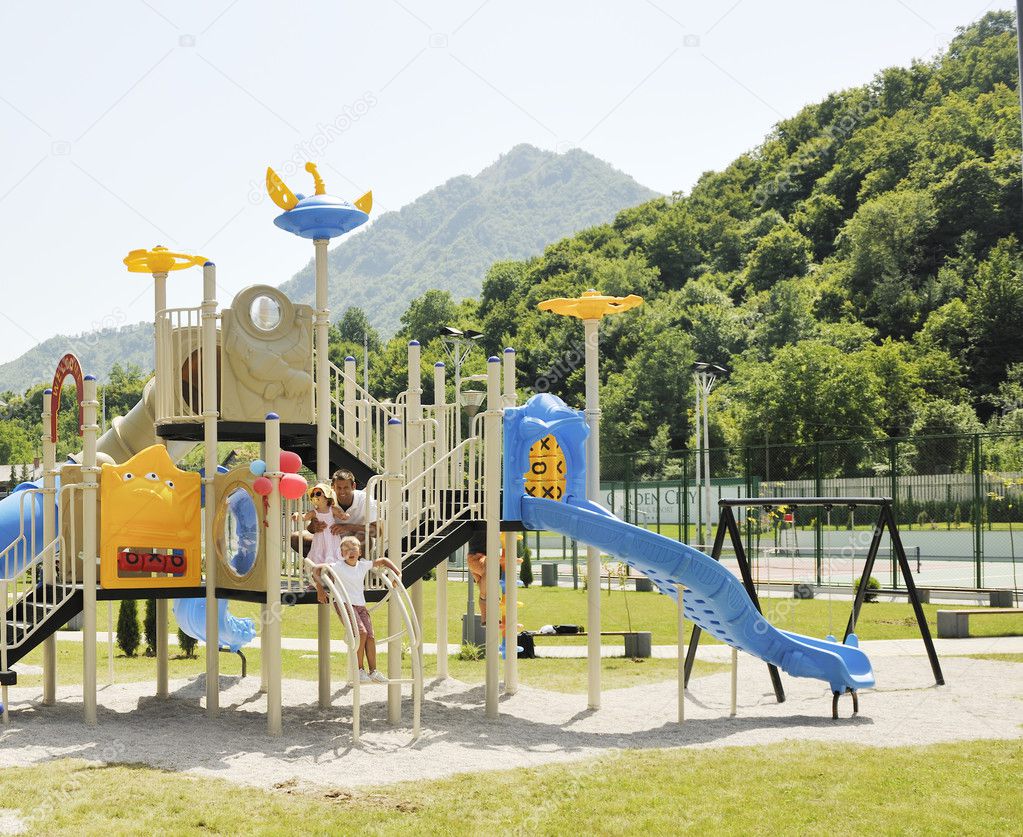 Young hapy family portrait at park playground