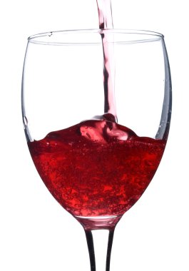 Pouring red wine in glass with bubbles