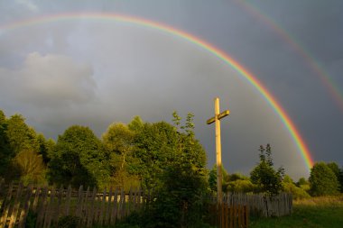 Cross and rainbow after rain clipart