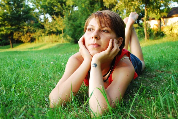 Girl in green grass — Stock Photo, Image