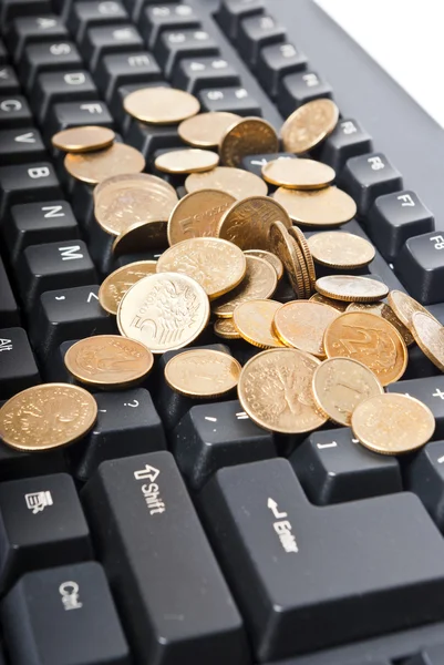Monedas en el teclado — Foto de Stock