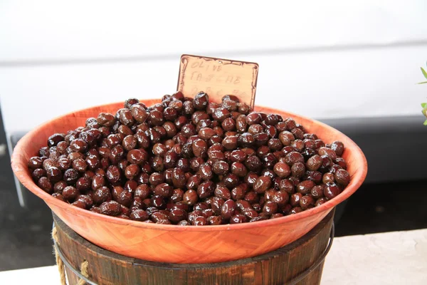 a bowl with black olives