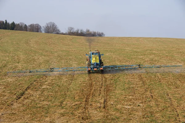 stock image Tractor spraying on field