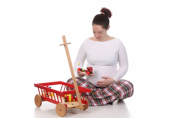 Těhotná žena a hračky — Stock fotografie