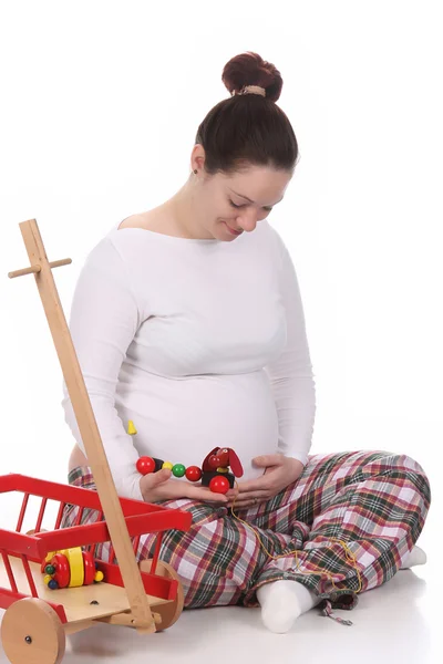 Mulher grávida e brinquedos — Fotografia de Stock