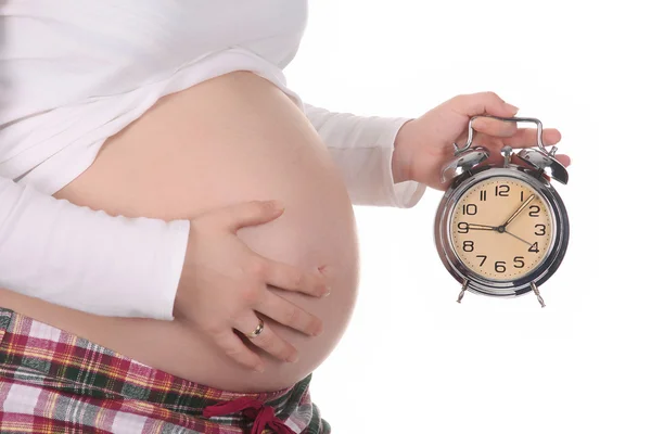 Pregnant woman with alarm clock waiting — Stock Photo, Image