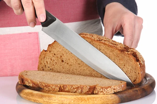 Cutting bread with knife — Stock Photo, Image