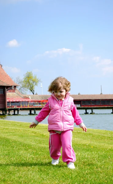 Маленькая девочка гонка на траве — стоковое фото