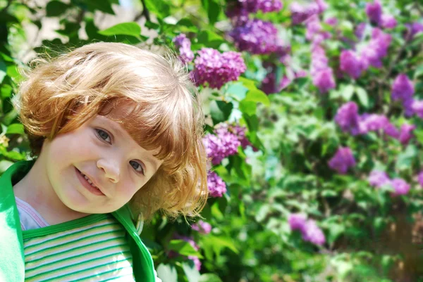 Little girl in lilac garden — Stock Photo, Image