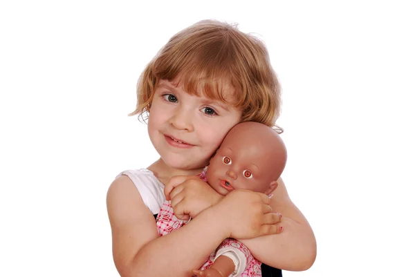 Little girl with baby doll toy — Stock Photo, Image