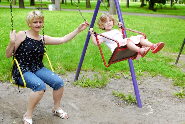 Mother and daughter on swing — Stock Photo, Image