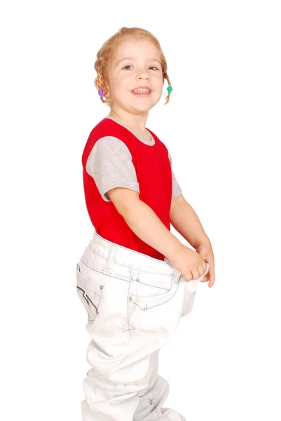 Glad liten tjej i stora byxor — Stockfoto