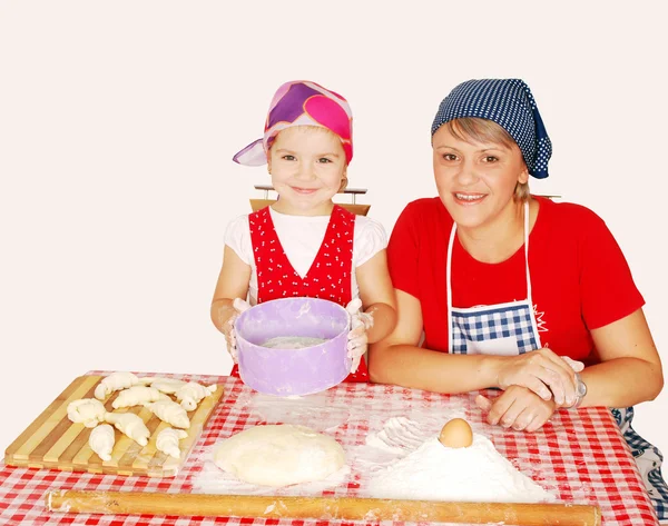 Mother and daughter make rolls with flour — Stock Photo, Image