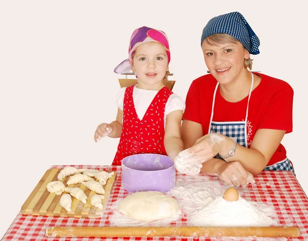 Mother and daughter with flour and rolls — Stock Photo, Image