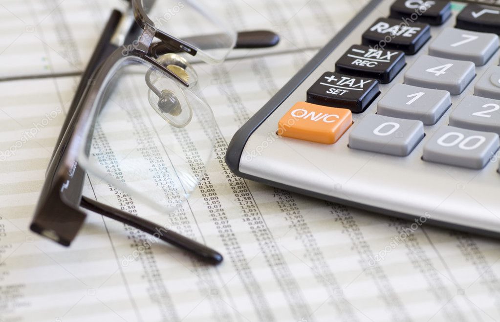 Calculator, glasses and finance