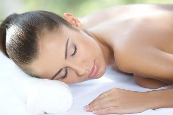 Beautiful woman is resting on spa bed — Stock Photo, Image