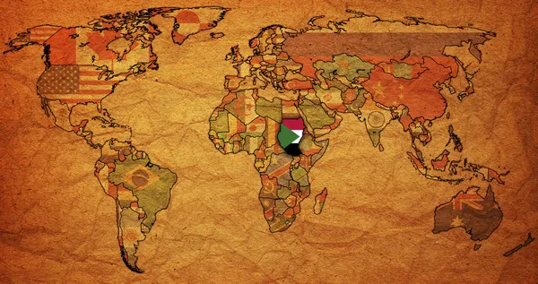 世界地図上のフラグとスーダン領土 — ストック写真