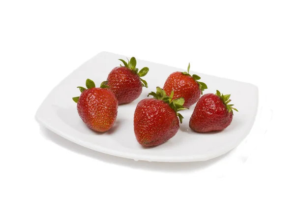 Ripe strawberry on a white plate — Stock Photo, Image