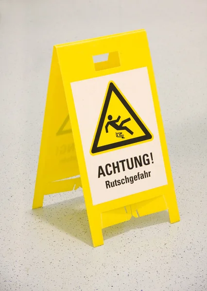 stock image Wet floor sign in german