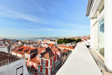 Window view to roofs of Lisbon clipart