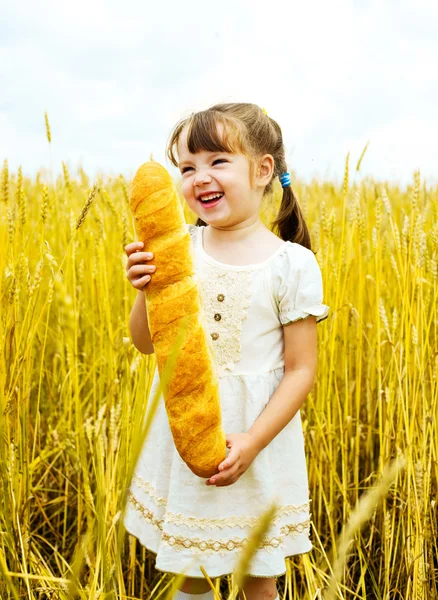 Girl with a long loaf — Stock Photo, Image