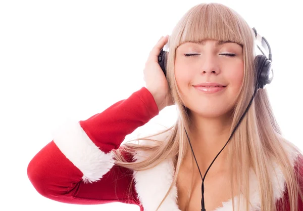 Meisje verkleed als santa luisteren naar de muziek — Stockfoto