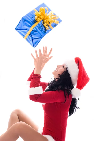 Beautiful brunette woman catching a Christmas pr — Stock Photo, Image