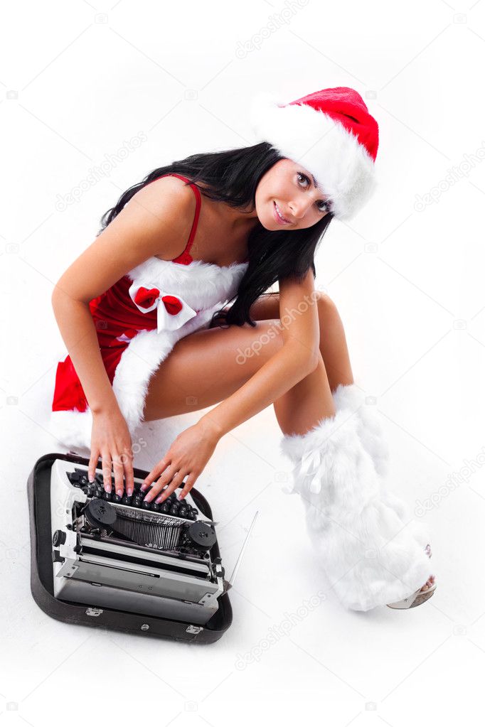 Girl dressed as Santa printing on the typewriter
