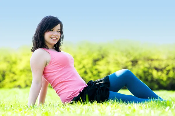 Young happy girl lying on grass — Stock Photo, Image