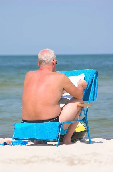 stock image Senior relaxing by reading newspaper