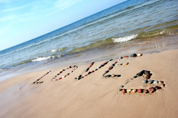 Λέξη αγάπη στην άμμο παραλία — Φωτογραφία Αρχείου