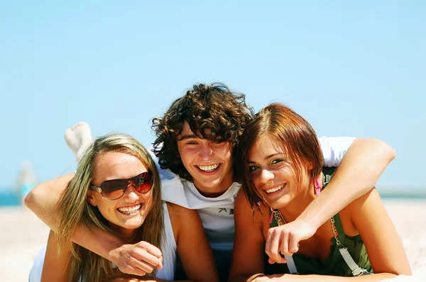 Unga vänner på stranden sommaren Royaltyfria Stockbilder