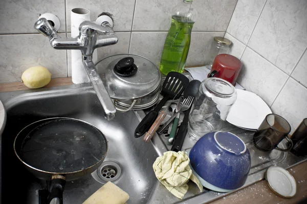 Stock image Pile of dirty dishes in the metal sink