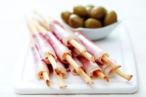 Stock image Grissini with ham and olives